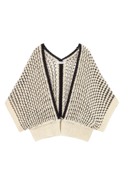 A cream and black knit poncho-style cardigan with a textured houndstooth-like pattern, ribbed trim, and a split V-neckline, shown flat on a white background.
