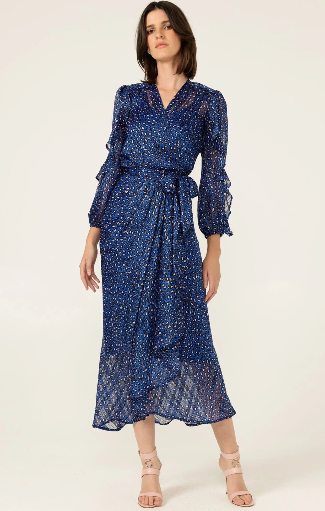 woman wearing Sacha Drake Shona Midi Wrap Dress with black and pink leopard print pattern on a white background