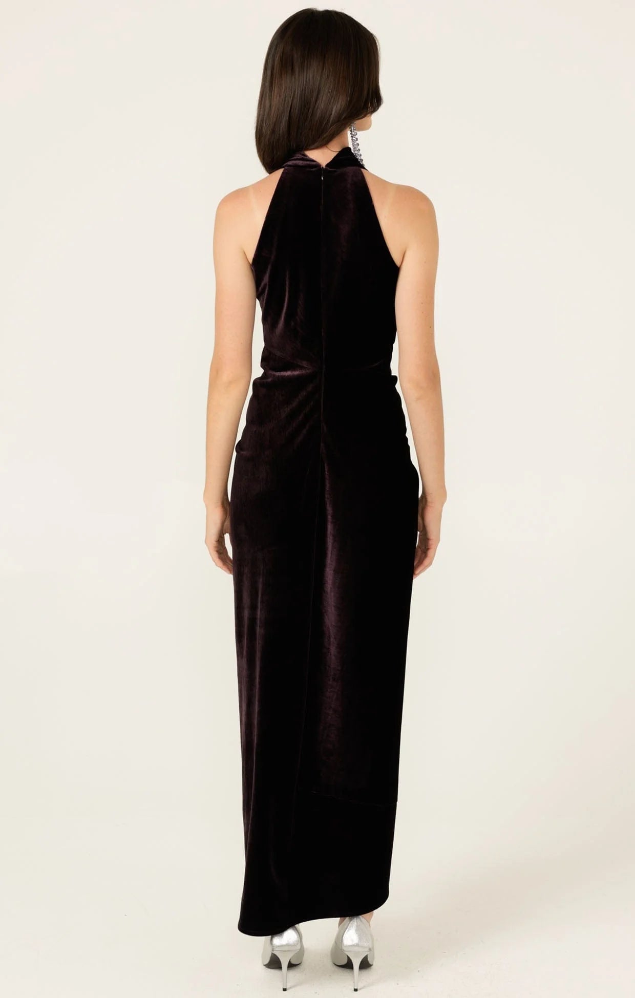 woman wearing sacha drake velvet dress facing backwards with a white background