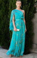 Model wearing one shoulder Sacha Drake Lorelei Maxi Dress in jade green and gold floral print